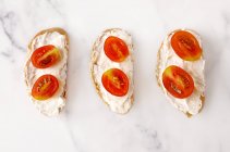 Baguette with cream cheese and fresh tomato — Stock Photo