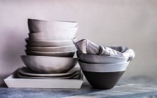 Stack of minimalist bowls and plates on a tray — Stock Photo