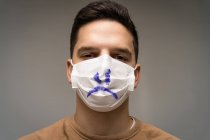 Portrait of a man wearing a face mask with a sad face — Stock Photo