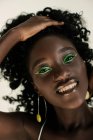 Portrait of a beautiful African woman with green make up — Stock Photo
