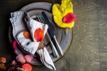 Autumnal place setting with autumn leaves — Stock Photo