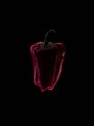 Silhouette of a red bell pepper against a black background — Stock Photo