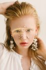 Portrait of a beautiful girl with pearls on her face — Stock Photo