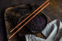 Raw organic black rice in a bowl as a asian cooking concept — Stock Photo