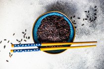Roher schwarzer Bio-Reis in einer Schüssel als asiatisches Kochkonzept — Stockfoto