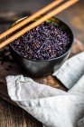 Raw organic black rice in a bowl as a asian cooking concept — Stock Photo