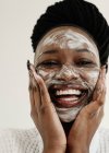 Portrait of a smiling woman with a face mask — Stock Photo