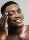 Portrait of a smiling man with glitter on his face — Stock Photo