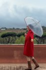 Mujer bailando bajo la lluvia con un paraguas, Roma, Lazio, Italia - foto de stock