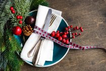 Festive table setting with empty plate, cutlery and decoration on rustic background with copy space — Stock Photo
