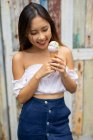 Smiling woman eating an ice-cream, Bali, Indonesia — Stock Photo