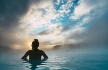 Silhouette of a woman standing in the Blue Lagoon, Iceland — Stock Photo