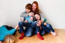 Portrait of a mother with her three children — Stock Photo