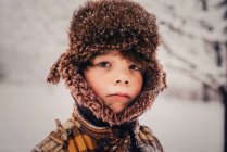 Porträt eines Jungen mit Jägermütze im Schnee, USA — Stockfoto