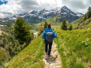 Woman hiking along a trail in Austrian Alps near Gastein, Salzburg, Austria — Stock Photo