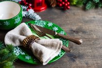 Christmas table setting with holiday decor on rustic table with copy space — Stock Photo