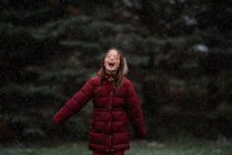 Glückliches Mädchen steht draußen im Schnee, USA — Stockfoto