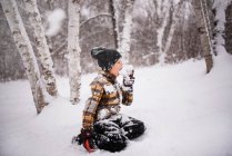 Ragazzo seduto all'aperto a mangiare neve, Wisconsin, USA — Foto stock