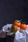 Close-up of four mandarins on a table — Stock Photo