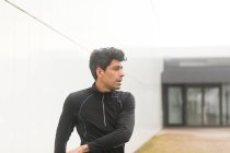 Portrait of a jogger standing outdoors warming up, Germany — Stock Photo