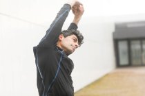 Portrait of a jogger standing outdoors warming up, Germany — Stock Photo