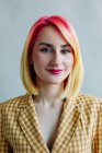Portrait of a cool girl with dyed hair wearing a suit — Stock Photo