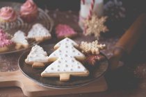 Christmas cookies, cupcakes and a bottle of milk — Stock Photo