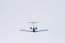 Low angle view of a small jet plane in flight — Stock Photo