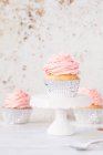 Three cupcakes with buttercream icing — Stock Photo