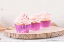 Three cupcakes with buttercream icing — Stock Photo