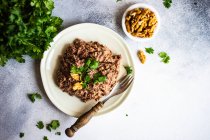 Traditional georgian bean dish - lobio with walnut, served in modern textured ceramic bowl on stone background with copy space — Stock Photo
