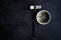 Place setting with chopsticks and a soy sauce bowl — Stock Photo