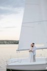 Portrait of a couple in love standing on a yacht, Russia — Stock Photo