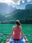 Rear view of a young woman kayaking, Molveno lake, Trentino, Italy — Stock Photo