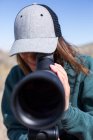 Mulher olhando através do escopo spotting, Wyoming, EUA — Fotografia de Stock