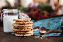 Stack of Chocolate chip cookies next to ingredients — Stock Photo