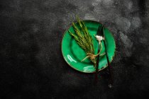 Bunch of tied rosemary decoration on a place setting — Stock Photo