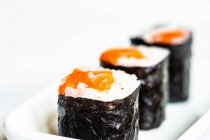 Close-up of three sake maki rolls on a plate — Stock Photo