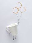 Conceptual mug person holding balloons — Stock Photo