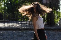 Teenage girl standing in the street spinning around, Argentina — Stock Photo