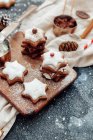 Christmas gingerbread cookies with icing sugar and cinnamon on a wooden background. — Stock Photo