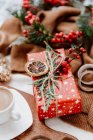 Xícara de café ao lado de um presente de Natal embrulhado — Fotografia de Stock