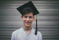Portrait of a smiling teenage boy at graduation, Spain — Stock Photo