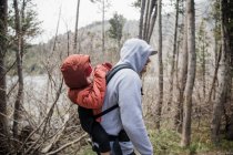 Father carrying his son on his back during a hike, California, United States — Stock Photo