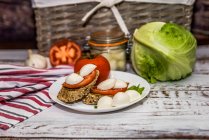 Mozzarella and tomato on bread — Stock Photo