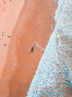 Aerial view of man with surf walking along Thirteenth beach, Victoria, Australia — Stock Photo