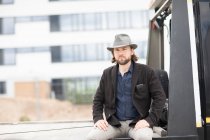 Portrait of a man sitting on the back of a truck — Stock Photo
