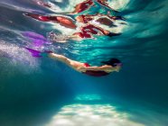 Girl swimming in a swimming pool — Stock Photo