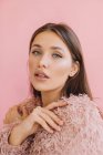 Retrato de una hermosa mujer sobre fondo rosa - foto de stock