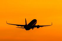 Aircraft taking off at sunset — Stock Photo